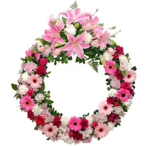 A sympathy wreath featuring pink flowers and pink lilies