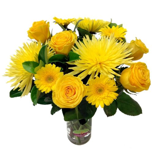 Vibrant mix of flowers in a clear vase