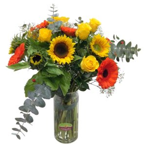 A beautiful flowers arrangement in a vase with sunflowers and roses
