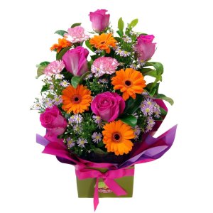 A beautiful bouquet of flowers arranged in a box, showcasing a vibrant and colorful floral arrangement