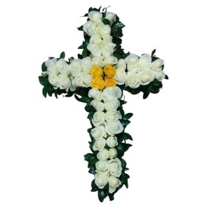 A white cross embellished with yellow roses and leaves, representing sympathy and offering solace