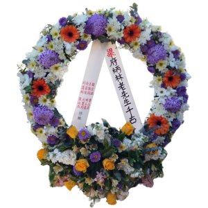 A circular arrangement of flowers, symbolizing condolences and support during times of grief