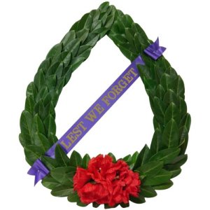A festive wreath adorned with a ribbon and a vibrant red flower