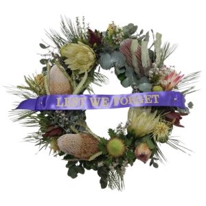 A circular arrangement of flowers and foliage, symbolizing remembrance and honor for fallen soldiers