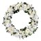 A sympathy wreath featuring a delicate arrangement of white flowers on a serene white background