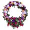 An elegant sympathy wreath adorned with flowers against a white backdrop