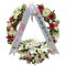 A sympathy wreath adorned with flowers and a ribbon