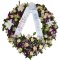 An elegant sympathy wreath embellished with flowers and a ribbon, expressing sincere sympathy and honoring a loved one