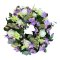 A sympathy wreath adorned with delicate purple and white flowers