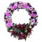 Sympathy wreath featuring pink and purple flowers on a white background