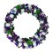 A beautiful wreath made of purple and white flowers, symbolizing elegance and purity