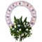 Sympathy wreath featuring a mix of flowers and greenery
