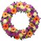 Sympathy wreath adorned with purple, orange, and yellow flowers