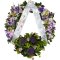 Wreath featuring purple and white flowers, with ribbon
